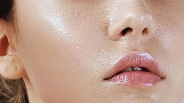 Khuôn mặt người phụ nữ với vùng da dầu bóng nhờn, minh họa lý do cần sữa rửa mặt chuyên biệt.